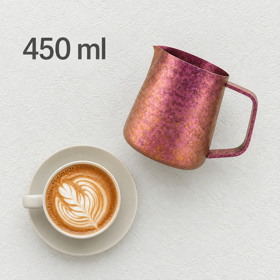 Pink 450 ml milk pitcher beside a latte, cup not included