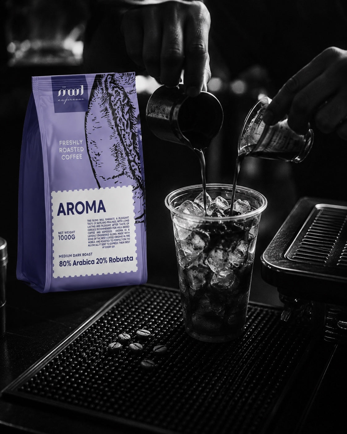 Mood Espresso Aroma 1 kg coffee bag beside an iced coffee being prepared