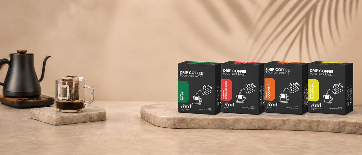 Four Mood Espresso drip coffee boxes with a kettle and a drip bag brewing in a glass cup